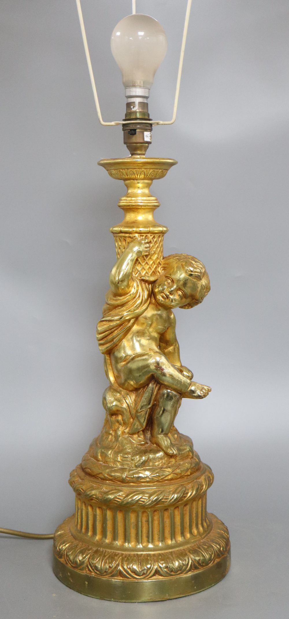 A gilt plaster cherub table lamp
